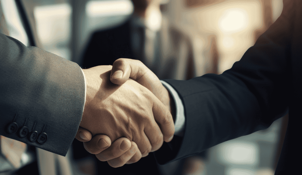 AD or CEO?: The Corporate Shift in College Athletics Two businessmen in suits shaking hands, symbolizing the corporate influence entering college athletics leadership roles