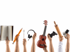 Your Athlete Is Also an Artist (And That’s a Win) Close-up of hands each holding a symbol of a different hobby or interest — such as a paintbrush, book, drumsticks, coding tablet, and sports ball — symbolizing the importance of nurturing students’ identities beyond athletics, including creative, academic, and personal pursuits.