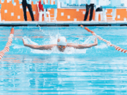 Will the SCORE Act Make or Break College Sports? A college swimmer in a non-revenue generating sport prepares to compete, representing the type of Olympic and smaller athletic programs that could be most impacted by the SCORE Act’s changes to college sports funding and governance.