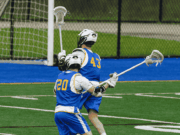 The “Adopt-a-Season” Sponsorship Model Lacrosse players in uniform running across the field during a game.