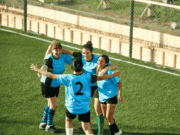 Are We Developing Leaders or Just Scoreboards? High school girls soccer team celebrating on the field, highlighting leadership development, teamwork culture, and athletic director priorities in school sports programs.