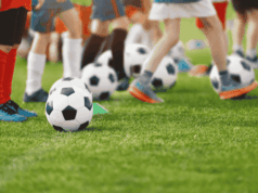 Why Youth Skills Camps Should Be Part of Every Athletic Program Youth soccer camp with children practicing ball control drills on a grass field during a youth sports skills training session.